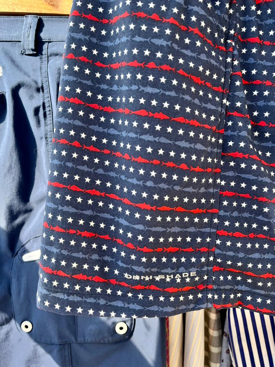 Short de baño Columbia con estampado de estrellas y rayas, colores azul marino, rojo y blanco, tejido de secado rápido, cintura elástica, bolsillo lateral.