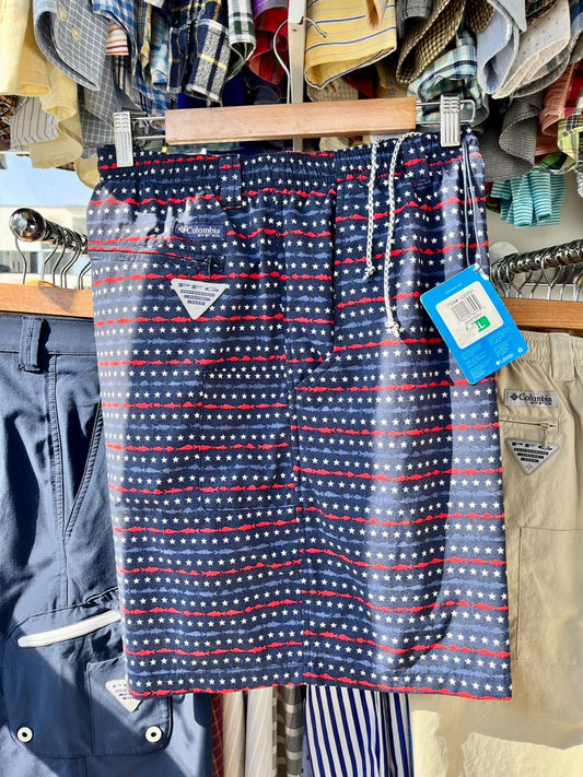 Short de baño Columbia con estampado de estrellas y rayas, colores azul marino, rojo y blanco, tejido de secado rápido, cintura elástica, bolsillo lateral.